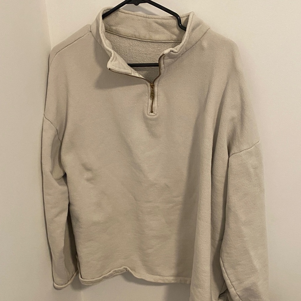 Gillian Steven’s Beige Zip-Up Sweater